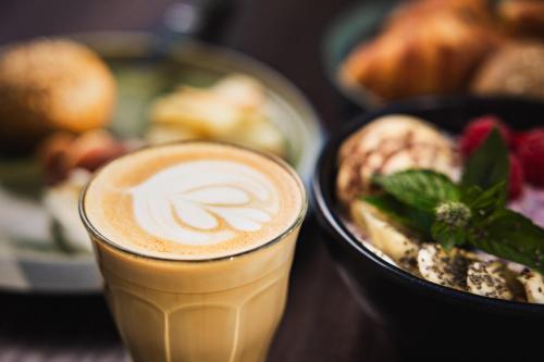 a cup of coffee sitting next to a plate of food at Radisson Blu Hotel, Lucerne in Luzern