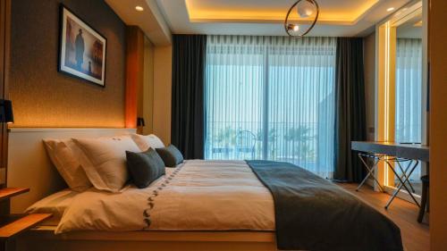 a bedroom with a large bed and a window at RUKA Hotel in Narlıdere