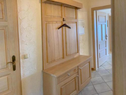 a room with a wooden cabinet and a door at Traudi in Waldkirchen