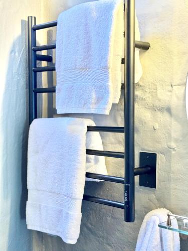 a towel rack in a bathroom with white towels at Elegant Colonial Walkable Casa in Jericó