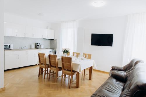 a kitchen and dining room with a table and chairs at FamilyVilla, new 4 Luxury Big Apartments, parking in Prague