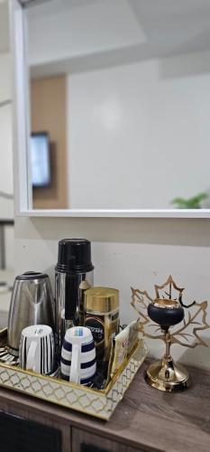 a kitchen counter with a tray with various appliances on it at Your Crib - kasara -19 D tower 1 in Manila