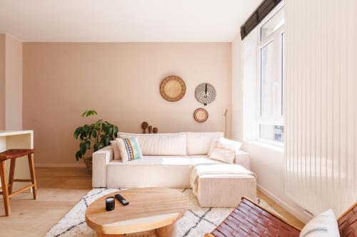 a living room with a couch and a table at L Ecrin d Ailleurs in Ath