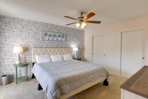 a bedroom with a bed and a ceiling fan at Sunny Tucson Townhome with Patio and Mountain Views! in Tucson