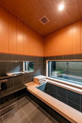 a kitchen with wooden walls and a window at Takayama Showa no yado-A Modern Japanese-style villa with garden, excellent location in Takayama