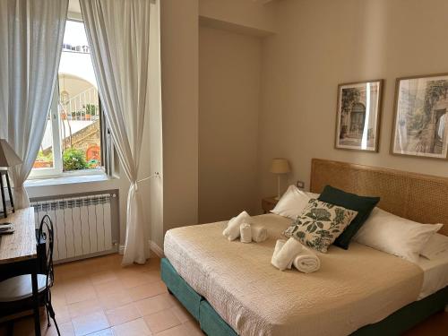 a bedroom with a bed with towels on it at Palazzo Gargano in Prignano Cilento