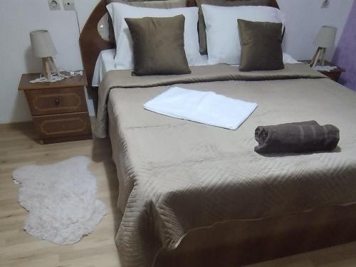 a bedroom with a large bed with a towel on it at The Guest Apartament 2 bedrooms Fier in Fier