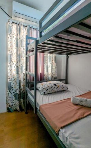 a bedroom with two bunk beds in a room at Cityloft Guesthouse in Tagbilaran City