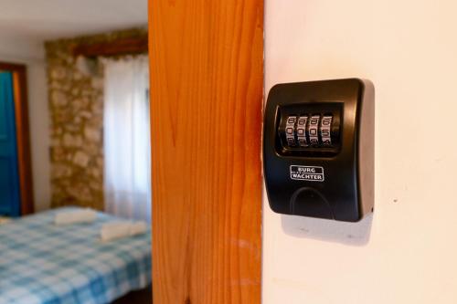 a close up of a remote control on a door at George's rooms in Stari Grad
