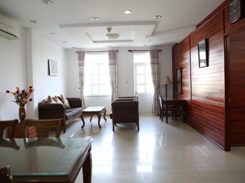 a living room with a couch and a table at Hoa Phat Hotel & Apartment in Ho Chi Minh City