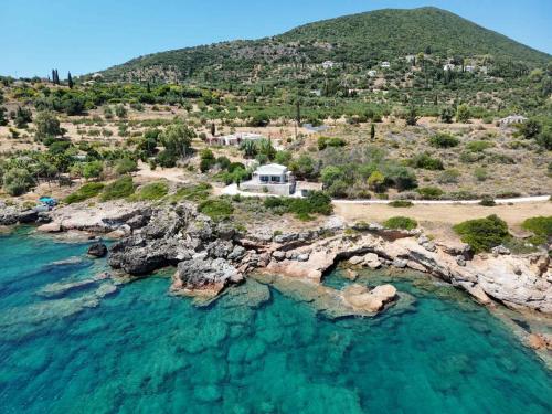 an aerial view of a house on a rocky island at Thalasson Beach House in Koroni