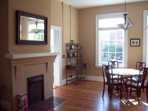 a living room with a table and a fireplace at Large Historic Downtown Loft Front in Macon