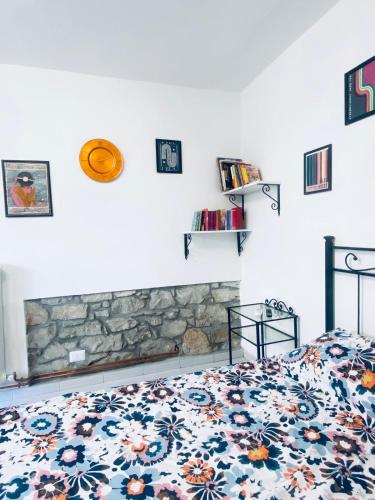 a bedroom with a bed and a fireplace at Il mio accogliente giardino all' italiana in San Giovanni Valdarno