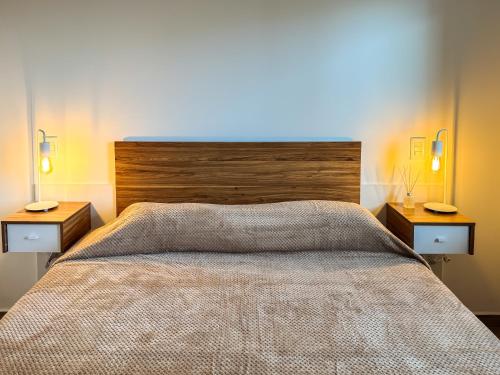 a bedroom with a large bed with two night stands at deptoquedateaqui in Olavarría