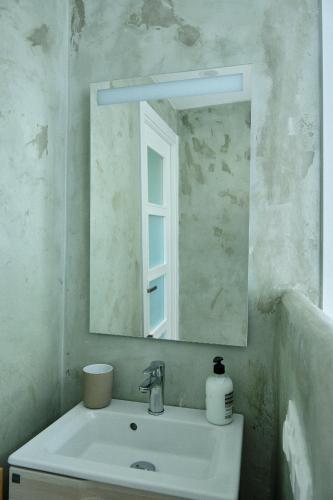 a bathroom with a sink and a mirror at Amazing Oceanfront 2br in Oropesa del Mar