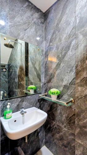 a bathroom with a sink and a mirror at Cityloft Guesthouse in Tagbilaran City