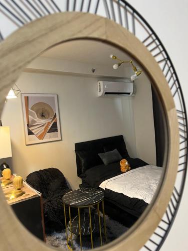 a bedroom with a bed and a round mirror at Bellvoir Luxe 2 in Suba
