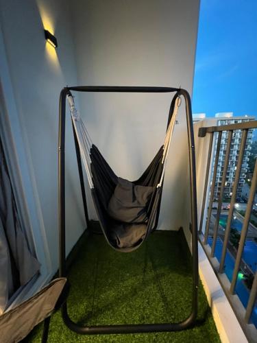 a hammock on the balcony of a apartment at Bellvoir Luxe 2 in Suba
