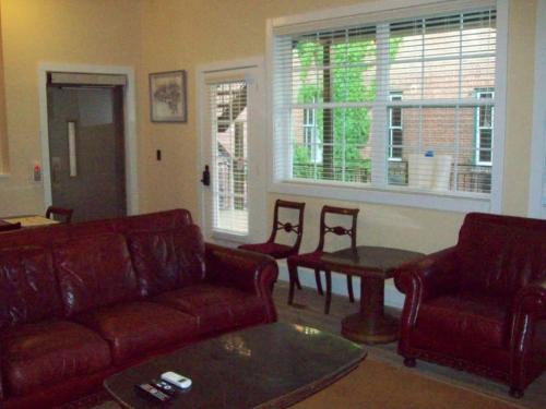 a living room with a couch and chairs and a table at Large Historic Downtown Loft - Rear in Macon