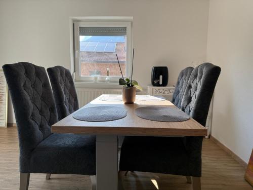 a dining room table with two chairs and a table with a plant at Jasmina Appartments in Jenbach