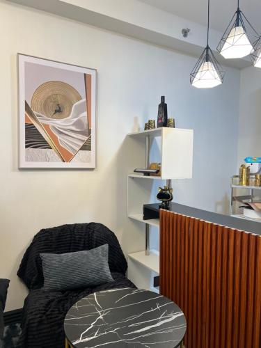 a living room with a chair and a table at Bellvoir Luxe 2 in Suba