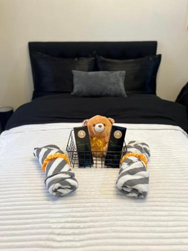 a teddy bear sitting in a cage on a bed at Bellvoir Luxe 2 in Suba