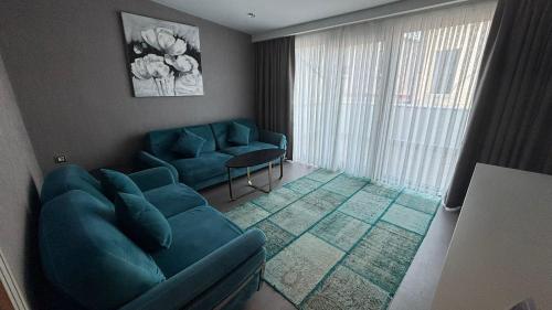 a living room with two blue chairs and a couch at Saygın Hotel Beşiktaş in Istanbul