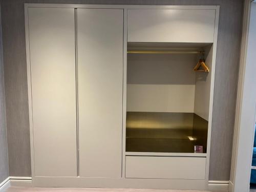 a white closet with a glass door at Saygın Hotel Beşiktaş in Istanbul
