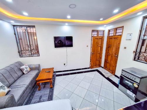 a living room with a couch and a table at Hidden palace Apartments in Mombasa