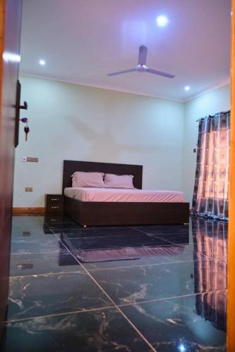a bedroom with a bed and a ceiling at Spaggy suites City escape in Obeyie
