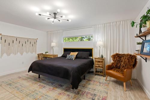 a bedroom with a bed and a chair at TX Sunset Ranch in Jonestown