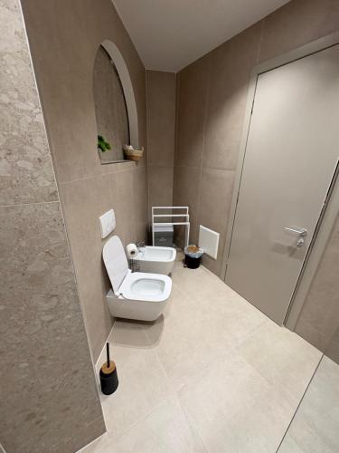 a bathroom with a toilet and a shower at Uzeiri Guest Hotel in Borsh