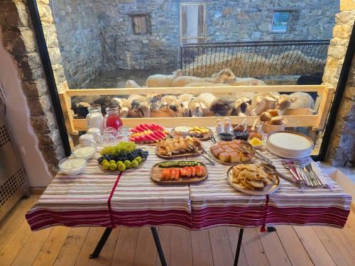 a table with many plates of food on it at Me Ra, Mrizi Zanave in Fishtë