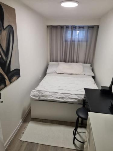 a small bedroom with a bed and a desk at Apartmán Zobor in Nitra