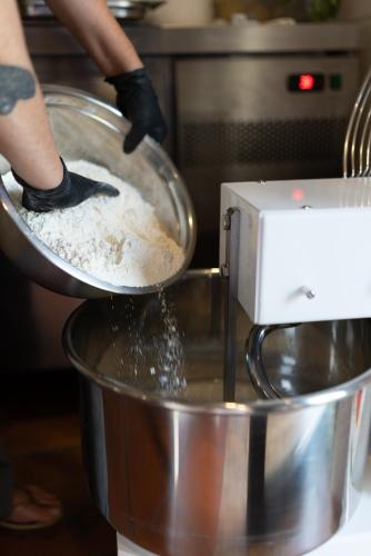 a person is mixing flour in a mixing bowl at Casa d'Amares in Amares