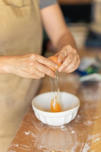 a person pouring sauce into a bowl on a counter at Casa d'Amares in Amares