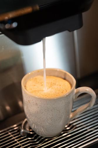 a cup of coffee being brewed in a coffeemachine at Casa d'Amares in Amares