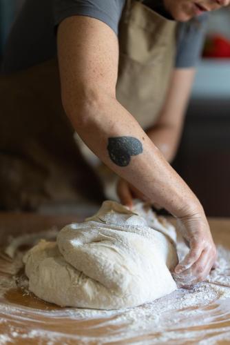 a person kneading the dough on a table at Casa d'Amares in Amares