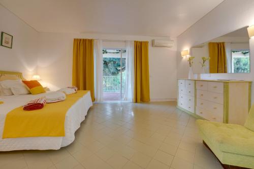 a bedroom with two beds and a dresser at Muthu Clube Praia da Oura in Albufeira