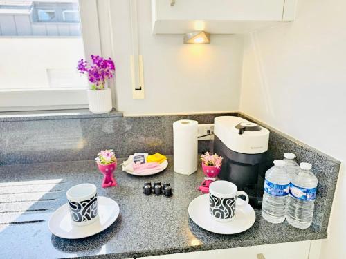 a kitchen counter with two cups and plates on it at Chic Urban Stay 2BR with parking- BEL4 in Luxembourg