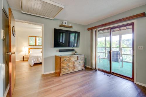 a bedroom with a bed and a television on a wall at Dock and Prime Location Lakefront Osage Beach Home in Osage Beach