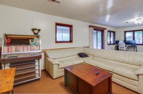 a living room with a couch and a table at Dock and Prime Location Lakefront Osage Beach Home in Osage Beach