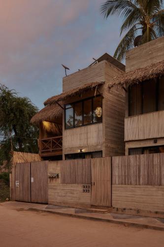 a building with a fence in front of it at Punta Tamarindo in Puerto Escondido