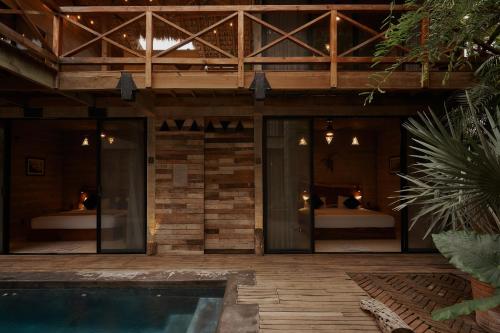 a villa with a swimming pool and a house at Punta Tamarindo in Puerto Escondido
