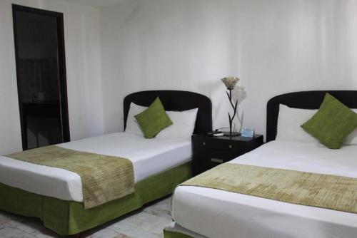 Una cama o camas en una habitación de Sunlight Hotel