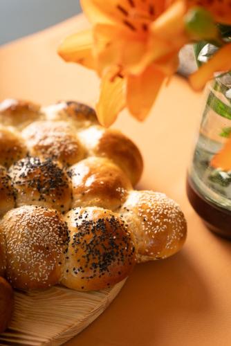 a pile of bagels on a plate next to a flower at Casa d'Amares in Amares