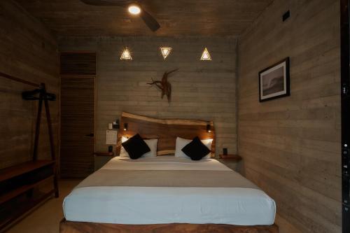 a bedroom with a large bed in a room at Punta Tamarindo in Puerto Escondido