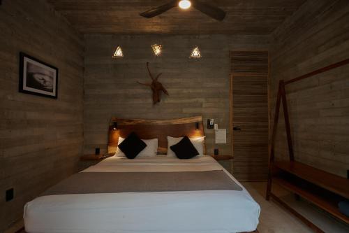 a bedroom with a large white bed in a room at Punta Tamarindo in Puerto Escondido