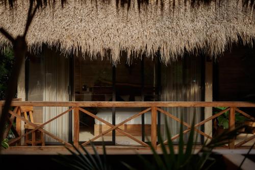 a hut with a straw roof and a wooden fence at Punta Tamarindo in Puerto Escondido