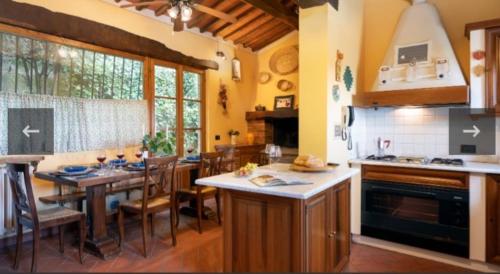 a kitchen with a table and a dining room at Podere Belvedere in Moncioni